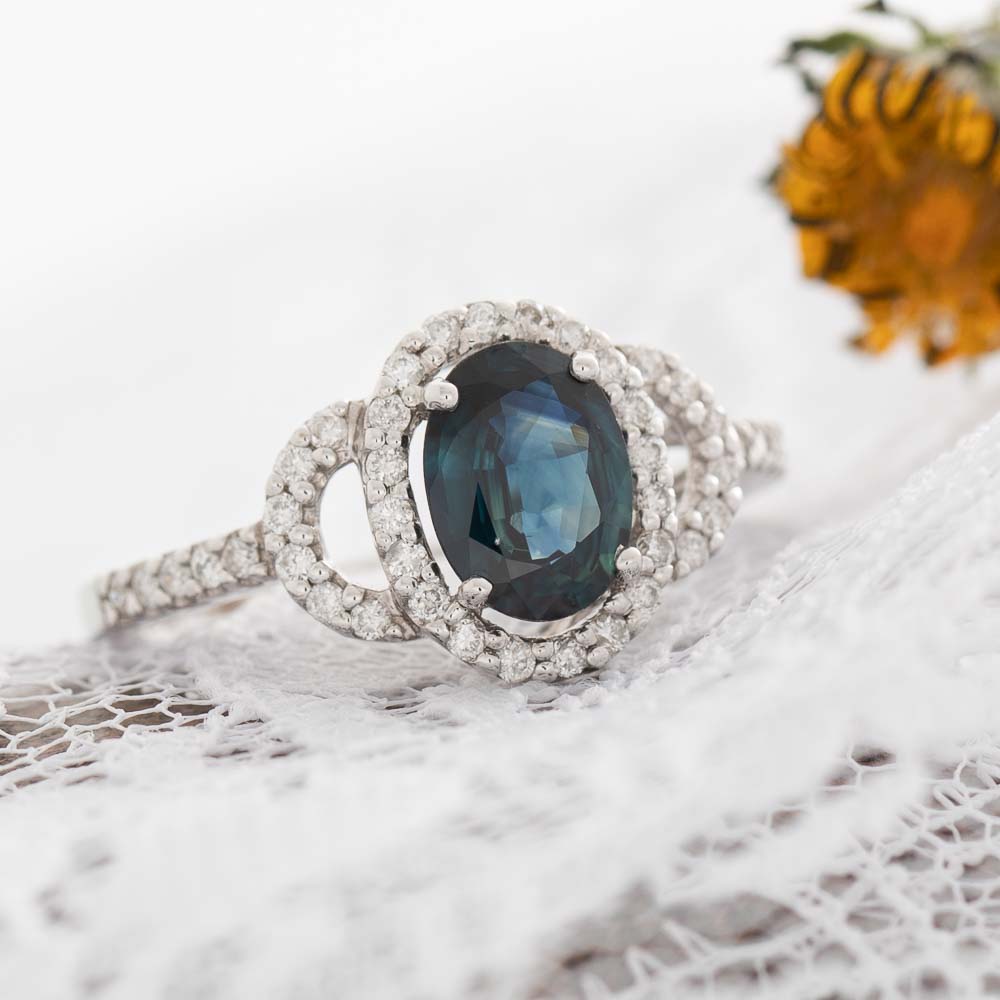 Blue Eyes electric blue sapphire with diamond halo in 14k white gold.