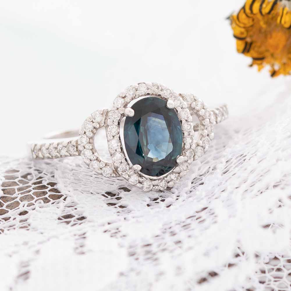 Blue Eyes electric blue sapphire with diamond halo in 14k white gold.