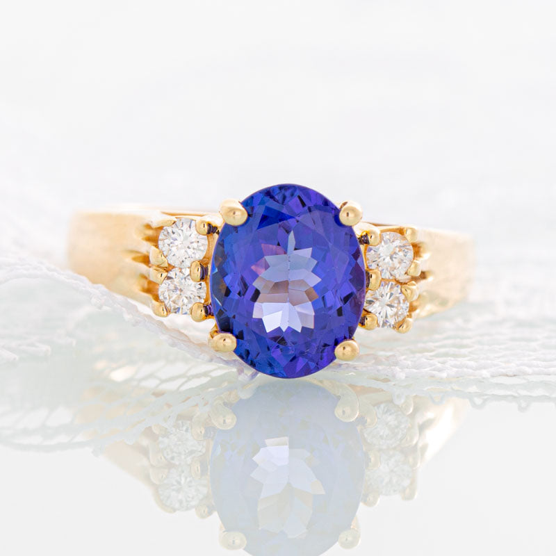Blue Oval Tanzanite ring with diamonds in 14k yellow