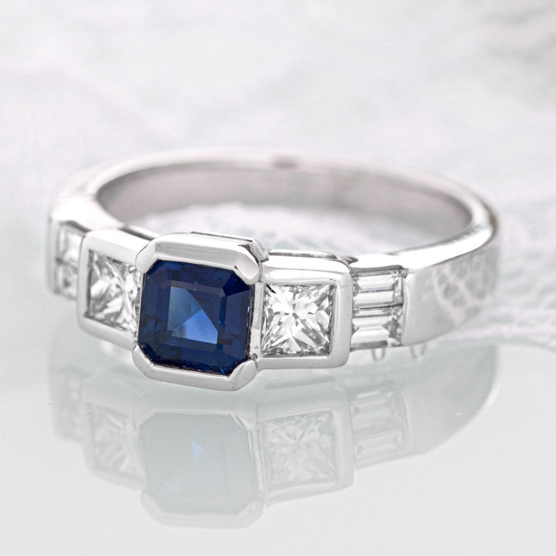Geometric blue sapphire ring with diamonds in 14k white gold.