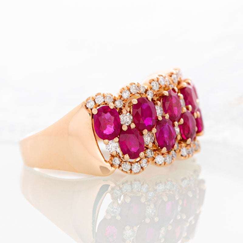Raspberry Wine Ruby Row ring with halo diamonds in 14k rose gold.