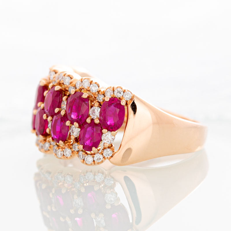 Raspberry Wine Ruby Row ring with halo diamonds in 14k rose gold.